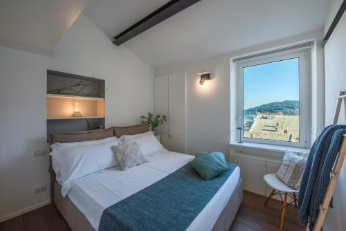 a bedroom with a large bed and a window at Casa Emily in Portovenere