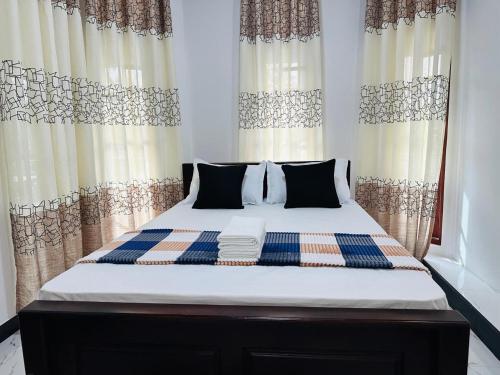 a bed in a bedroom with curtains in a room at Yala Dream Wild Resort in Tissamaharama