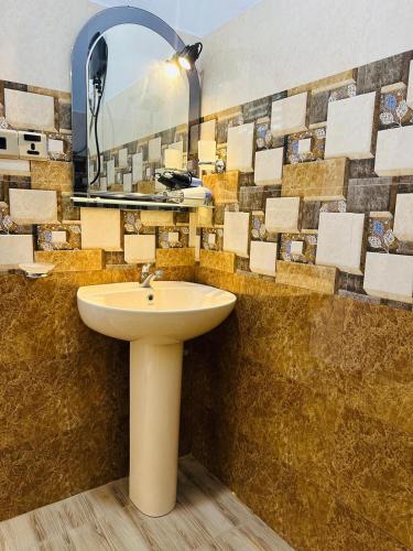 a bathroom with a sink and a mirror at Yala Dream Wild Resort in Tissamaharama