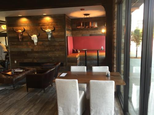 a dining room with a table and chairs and horns on the wall at Firebrand Hotel in Whitefish