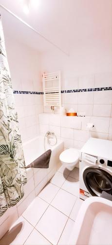 a white bathroom with a sink and a toilet at BetterBeds Wilhelm City in Brandenburg an der Havel