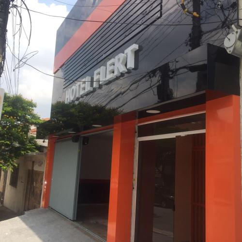 a front of a building with a sign on it at Hotel Flert - Tatuapé in Sao Paulo