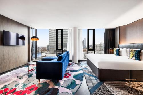 a hotel room with a bed and a couch at Riu Plaza London The Westminster in London