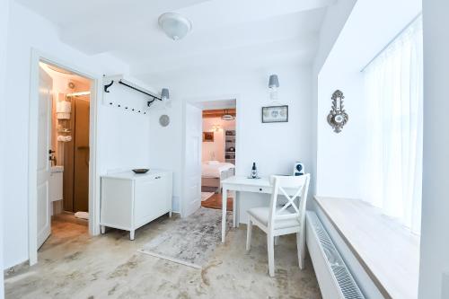 a white room with a desk and a table at Casa Baritiu - budget in Braşov