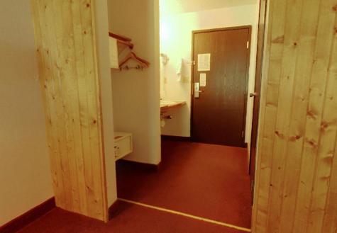 a room with a hallway with a door and a bathroom at Americas Best Value Inn - Duluth Spirit Mountain Inn in Duluth