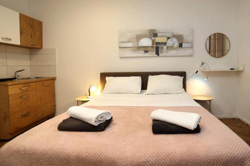 a bedroom with a large bed with two pillows at DJ Pula Studio - City Center in Pula