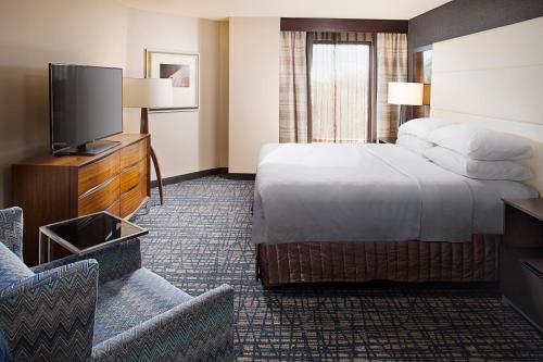 a hotel room with a bed and a flat screen tv at Crowne Plaza Annapolis by IHG in Annapolis