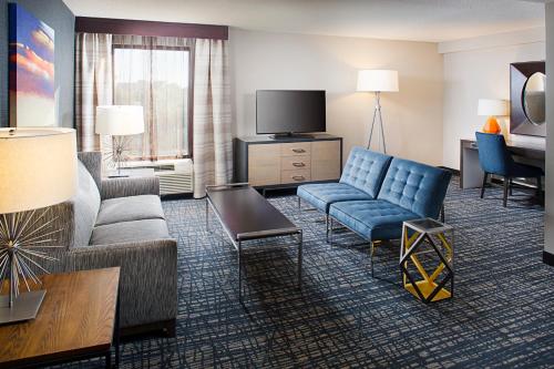 a hotel room with a couch and a tv at Crowne Plaza Annapolis by IHG in Annapolis