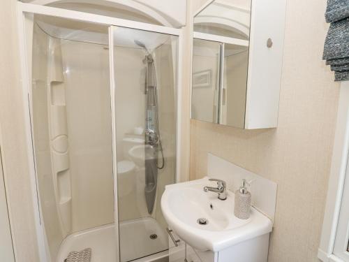 a bathroom with a shower and a sink at Plot 42 in Carlisle