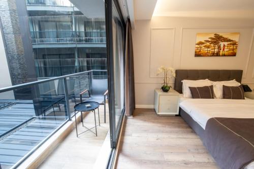 a bedroom with a bed and a balcony at Myway Deluxe Hotel in Konak