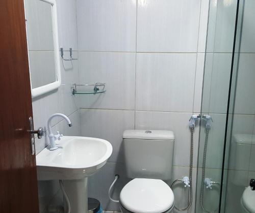 a bathroom with a toilet and a sink and a shower at Flat Visual do Porto in Fernando de Noronha