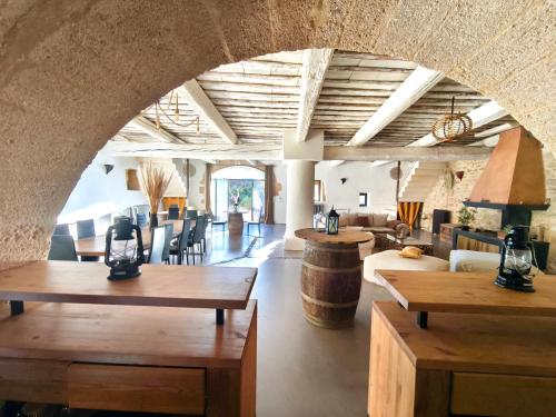 a living room with tables and chairs and a room with a barrel at Maison d'hôte Mas de Castille entre Uzès et le pont du Gard in Argilliers