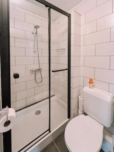 a bathroom with a shower with a toilet and a sink at Hotel Le Genepy in Tignes