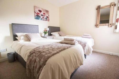 a bedroom with two beds and a window at South Groathill - Lovely 2 bed with Castle View in Edinburgh