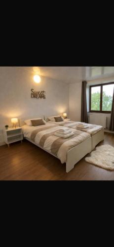 a bedroom with a large bed in a room at Les Lilas in Marche-en-Famenne
