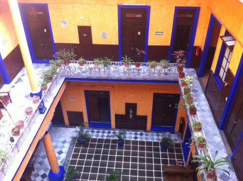 an overhead view of a building with potted plants at Hotel Isabel in Mexico City