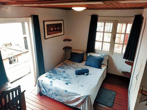 a bedroom with a bed in a room with a window at La lanterne in Antananarivo