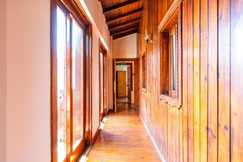 a hallway of a house with wooden walls and windows at Amazon Petite Palace in Selçuk