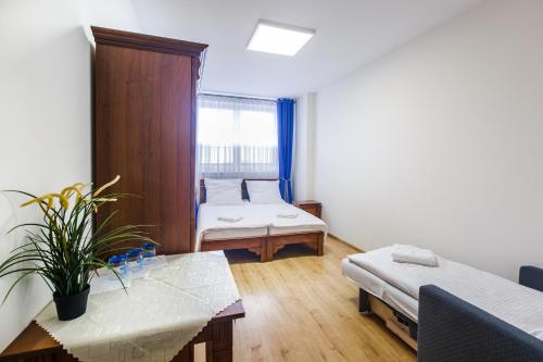 a living room with two beds and a table at BABIOGÓRSKA B&B in Zubrzyca Górna