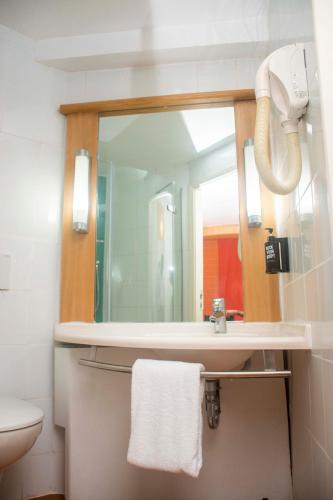 a bathroom with a sink and a mirror at Delta Continental Hotel and Suite, Lagos in Lagos