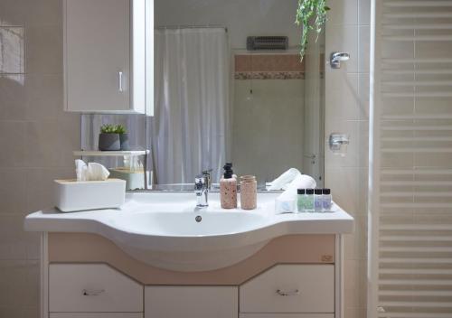 a bathroom with a white sink and a shower at Modern retreat near Ancient Olympia and sandy beach in Káto Samikón