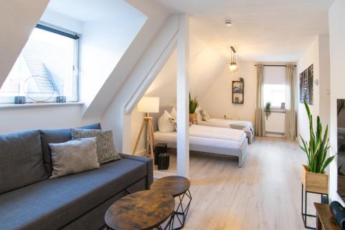 a living room with a couch and a bed at EasyGoing Switch Streaming schönes Apartment 6 Personen in Arnsberg