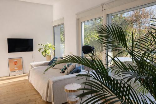 a living room with a bed and a large window at STUDIO 14 - apt design con terrazza sul fiume - 2 biciclette incluse - vicino al centro in Treviso