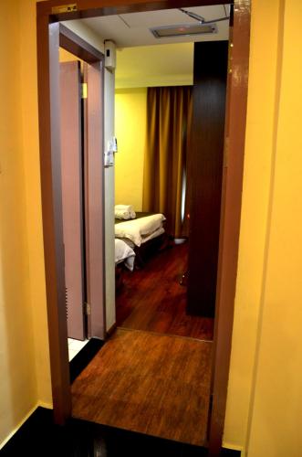 an open door to a room with a bedroom at Lintas Plaza Hotel in Kota Kinabalu