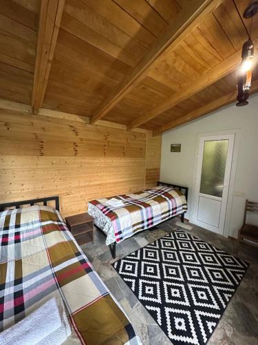 a room with two beds in a log cabin at Eco Garden Dilijan in Dilijan