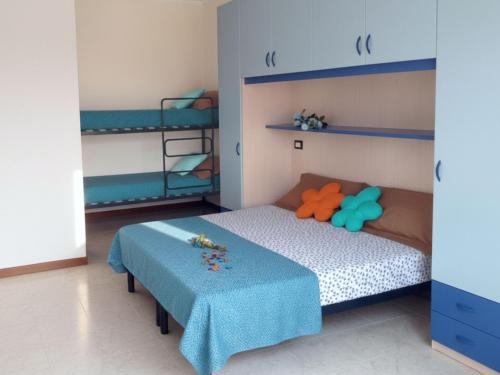 a bedroom with a bed and a bunk bed at Residence Silver Sail in Bibione