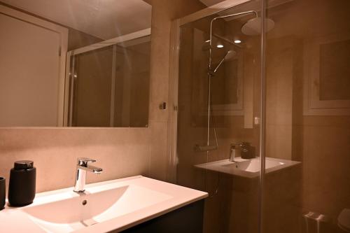 a bathroom with a sink and a shower at Brand New! Fresh Kolonaki Studio in Athens