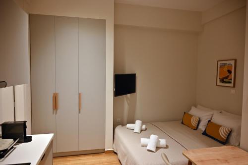 a bedroom with a bed with two white towels on it at Brand New! Fresh Kolonaki Studio in Athens