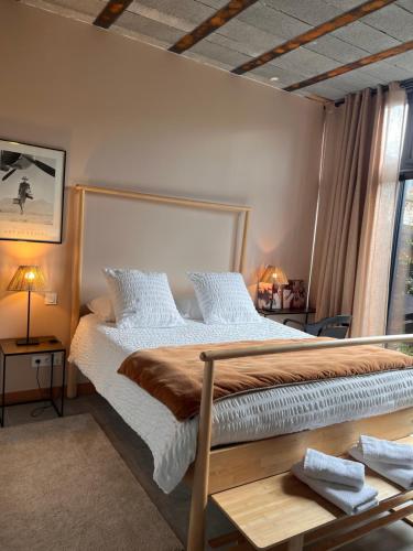 a bedroom with a large bed and a window at La Sellerie in Romagné