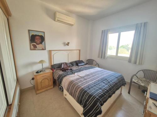 a bedroom with a bed and a window at K31 Peaceful 2 Bedrooms Nile Resort Flat in Luxor in Luxor