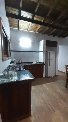 a kitchen with a stove and a refrigerator at Duplex La Caleta Mar in Mar de Cobo
