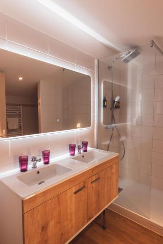 a bathroom with a sink and a shower at Golf Resort de Digne-les-Bains by Adonis in Digne-les-Bains