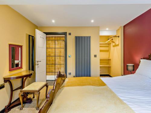 a bedroom with a bed and a desk and a table at 2 Bed in Stoke-on-trent oc-94790 in Waterhouses