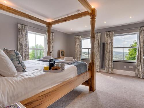 a bedroom with a large bed with a wooden frame at 7 Bed in Matlock oc-89448 in Matlock Bank