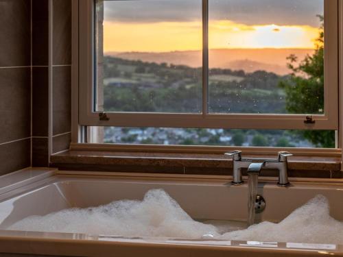 a bath tub filled with snow in front of a window at 7 Bed in Matlock oc-89448 in Matlock Bank