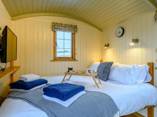 a bedroom with a large bed with a table on it at 1 Bed in Rhayader oc-90284 in Saint Harmon