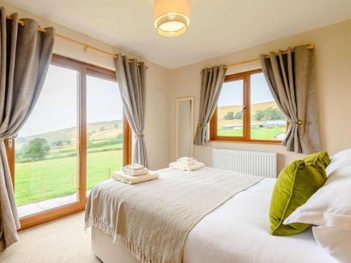 a bedroom with a bed and a large window at 2 Bed in Llandrindod Wells oc-89063 in Nantmel