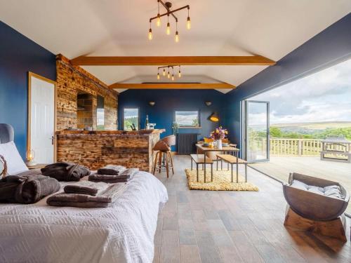 a bedroom with a large bed and a table and chairs at 1 Bed in Abergavenny oc-88015 in Llanover