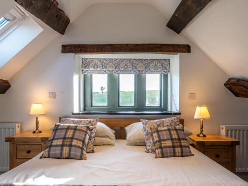a bedroom with a large white bed with two lamps at 4 Bed in Denbigh oc-62947 in Llannefydd