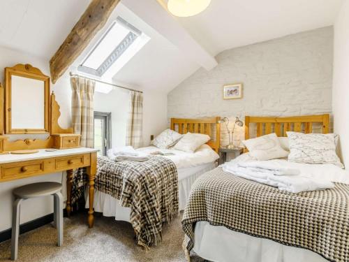 a bedroom with two beds and a desk and a sink at 2 Bed in Brecon oc-bn100 in Cray