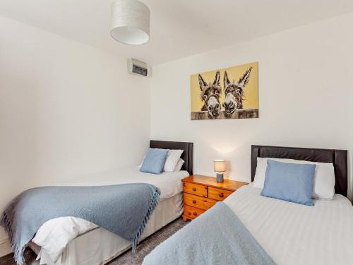 a bedroom with two twin beds and a night stand at 2 Bed in Bristol oc-05135 in Chew Magna