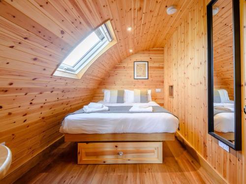 a bedroom with a bed in a wooden house at 2 Bed in Rhayader oc-90280 in Saint Harmon