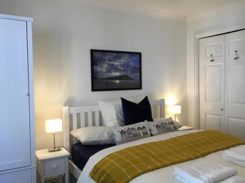 a bedroom with a bed and two lamps and a tv at 2 Bed in Minehead oc-75338 in Minehead