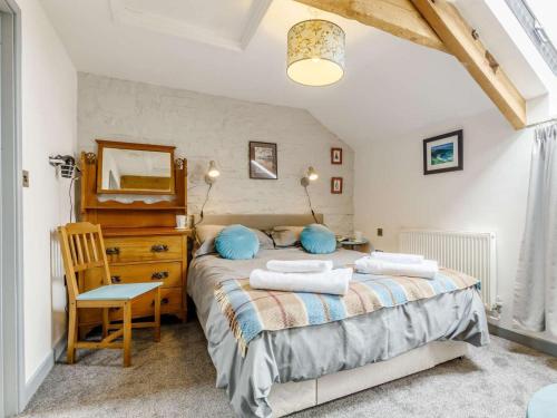 a bedroom with a bed and a wooden dresser at 2 Bed in Brecon oc-bn310 in Cray