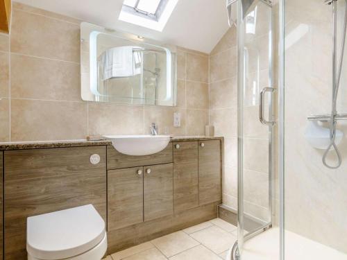 a bathroom with a toilet and a sink and a shower at 2 Bed in Brecon oc-bn310 in Cray