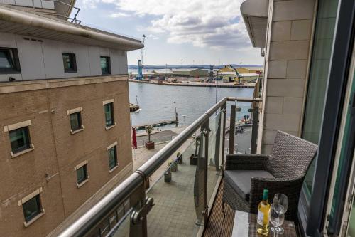 a balcony with a view of a body of water at Isle be Back - Harbour front Views from Balconies in Poole